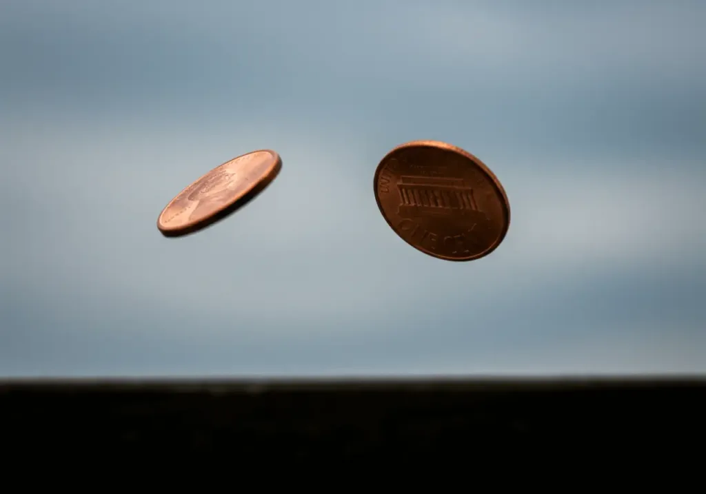 Spinning coin in the air, equal chances of heads and tails.